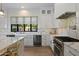 Stylish kitchen with white cabinetry, marble countertops, stainless steel appliances, and wine cooler at 3808 E Fairmount Ave, Phoenix, AZ 85018