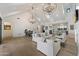 Spacious living room features high vaulted ceilings, chandeliers, ample seating, and seamless flow to dining and kitchen areas at 3808 E Fairmount Ave, Phoenix, AZ 85018