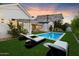 Beautiful backyard features a sparkling pool, lush landscaping, and lounge chairs at 3808 E Fairmount Ave, Phoenix, AZ 85018
