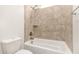 Close-up of a bathtub and tiled shower with a toilet in a bright, modern bathroom at 3894 E Dogwood Pl, Chandler, AZ 85286