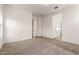 Bright, carpeted bedroom with access to other rooms, providing a versatile living space at 3894 E Dogwood Pl, Chandler, AZ 85286