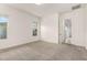 Well-lit bedroom with neutral carpet and trim, and multiple windows providing natural light and outdoor views at 3894 E Dogwood Pl, Chandler, AZ 85286