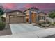 Single-Gathering home featuring a stone facade, a two car garage and wide driveway at 3894 E Dogwood Pl, Chandler, AZ 85286
