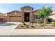 Charming single-story home featuring a stone facade, desert landscaping, and a two car garage at 3894 E Dogwood Pl, Chandler, AZ 85286