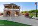 Two story gazebo with stone arches and a view of the pond and surrounding greenery at 3894 E Dogwood Pl, Chandler, AZ 85286