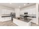 Modern kitchen with white cabinets, stainless steel appliances, and a large island at 3894 E Dogwood Pl, Chandler, AZ 85286