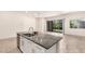 Modern kitchen island with gray countertops and stainless steel appliances overlooking the living area at 3894 E Dogwood Pl, Chandler, AZ 85286