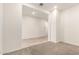 A spacious room showcasing an open doorway with carpeted floors and neutral walls at 3894 E Dogwood Pl, Chandler, AZ 85286