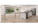 Bright living space with a modern kitchen, sliding glass doors to the backyard, and wood-look flooring at 3894 E Dogwood Pl, Chandler, AZ 85286