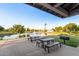 Covered picnic area with tables overlooking a scenic pond and fountain at 3894 E Dogwood Pl, Chandler, AZ 85286