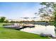 Beautiful sunset view of the pond with a pier and walking path by the water at 3894 E Dogwood Pl, Chandler, AZ 85286