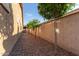 A view of the home's side yard, enclosed with a block fence and gravel at 3894 E Dogwood Pl, Chandler, AZ 85286