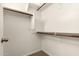 Spacious walk-in closet with built-in shelving and wooden racks, designed for optimal organization and storage at 3894 E Dogwood Pl, Chandler, AZ 85286