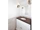 Charming bathroom featuring a wood vanity, designer mirror, and attractive lighting at 3931 E Crest Ln, Phoenix, AZ 85050