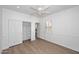 Light-filled bedroom with wood floors, closet with sliding doors and plantation shutters at 3931 E Crest Ln, Phoenix, AZ 85050