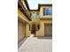 Inviting home exterior with a decorative arched entrance, brown shutters, and a paver driveway at 3931 E Crest Ln, Phoenix, AZ 85050