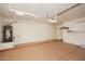 Spacious garage featuring overhead storage racks and a water heater at 3931 E Crest Ln, Phoenix, AZ 85050