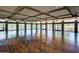 A large room with hardwood floors, stone columns, lots of windows, and recessed lighting at 3931 E Crest Ln, Phoenix, AZ 85050