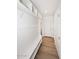 Bright hallway featuring white walls with storage and bench alongside wood flooring, offering both style and functionality at 3931 E Crest Ln, Phoenix, AZ 85050