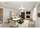 Cozy living room with a stone fireplace, modern ceiling fan, and lots of natural light at 3931 E Crest Ln, Phoenix, AZ 85050