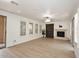 Open living area with a stone fireplace, modern ceiling fan and plantation shutters for bright natural light at 3931 E Crest Ln, Phoenix, AZ 85050