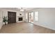 Open living area with a stone fireplace and sliding doors opening to pool area at 3931 E Crest Ln, Phoenix, AZ 85050