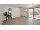 Bright living room with hardwood floors and an adjacent view of outdoor pool and spa at 3931 E Crest Ln, Phoenix, AZ 85050