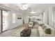 Spacious living room with an open floor plan, neutral decor, and seamless access to the kitchen at 3931 E Crest Ln, Phoenix, AZ 85050