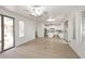 Open living space with wood flooring connecting to kitchen and outdoor patio at 3931 E Crest Ln, Phoenix, AZ 85050