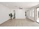 Spacious living room featuring light-colored floors, an arched entryway, and large windows at 3931 E Crest Ln, Phoenix, AZ 85050
