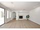 Bright living room with stone fireplace, wood floors, recessed lights, and sliding glass doors at 3931 E Crest Ln, Phoenix, AZ 85050