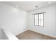 Small loft with luxury vinyl plank flooring, neutral paint, and a modern window at 3931 E Crest Ln, Phoenix, AZ 85050
