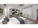 Bright main bedroom featuring a fireplace, sitting area, ceiling fan and light hardwood flooring at 3931 E Crest Ln, Phoenix, AZ 85050