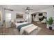 Relaxing bedroom featuring hardwood floors, neutral decor, and seamless access to the living room at 3931 E Crest Ln, Phoenix, AZ 85050