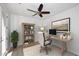 Bright home office featuring a modern desk, bookcase, and comfortable chair, perfect for working from home at 3931 E Crest Ln, Phoenix, AZ 85050