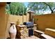 Outdoor grilling area with a stone built-in grill and adjacent countertops perfect for cooking and entertaining outdoors at 3931 E Crest Ln, Phoenix, AZ 85050
