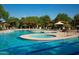 Beautiful community pool with covered seating areas and manicured landscaping at 3931 E Crest Ln, Phoenix, AZ 85050