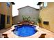A sparkling blue pool and spa with a charming waterfall feature, surrounded by a spacious terracotta tile patio at 3931 E Crest Ln, Phoenix, AZ 85050