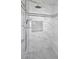 Luxurious shower featuring marble walls, and decorative black-and-white accent tiles at 3931 E Crest Ln, Phoenix, AZ 85050