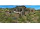 Contemporary home features a pool, outdoor fireplace, and seating at 39878 N 105Th Way, Scottsdale, AZ 85262
