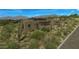 Exterior of desert home features a decorative stone porch and xeriscaped yard at 39878 N 105Th Way, Scottsdale, AZ 85262