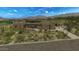 A contemporary single story home showcasing desert landscaping, mountain views and a brick paver driveway at 39878 N 105Th Way, Scottsdale, AZ 85262