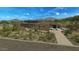 An upscale modern single story home featuring desert landscaping and a brick paver driveway at 39878 N 105Th Way, Scottsdale, AZ 85262