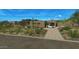 Desert home exterior with a driveway and two-car garage nestled in the desert at 39878 N 105Th Way, Scottsdale, AZ 85262
