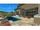 Beautiful backyard featuring a swimming pool, spa, outdoor kitchen area, stone pillars, and covered patio at 39878 N 105Th Way, Scottsdale, AZ 85262