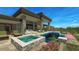 Modern backyard oasis including pool, spa, outdoor kitchen, stone pillars and outdoor furniture for relaxing at 39878 N 105Th Way, Scottsdale, AZ 85262