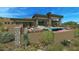 Backyard featuring a pool, spa, patio area with fireplace, grill and desert landscaping at an upscale modern home at 39878 N 105Th Way, Scottsdale, AZ 85262