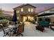 Spacious backyard patio with stylish outdoor furniture, including dining and seating areas and a built in fire pit at 40807 N Barnum Way, Anthem, AZ 85086