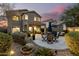 Expansive backyard with a covered patio, dining area, and beautifully landscaped surroundings at 40807 N Barnum Way, Anthem, AZ 85086