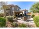 Beautifully landscaped backyard with multiple seating arrangements and vibrant plants at 40807 N Barnum Way, Anthem, AZ 85086